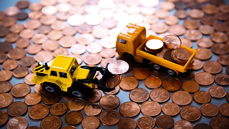 Toy cars among copper coins