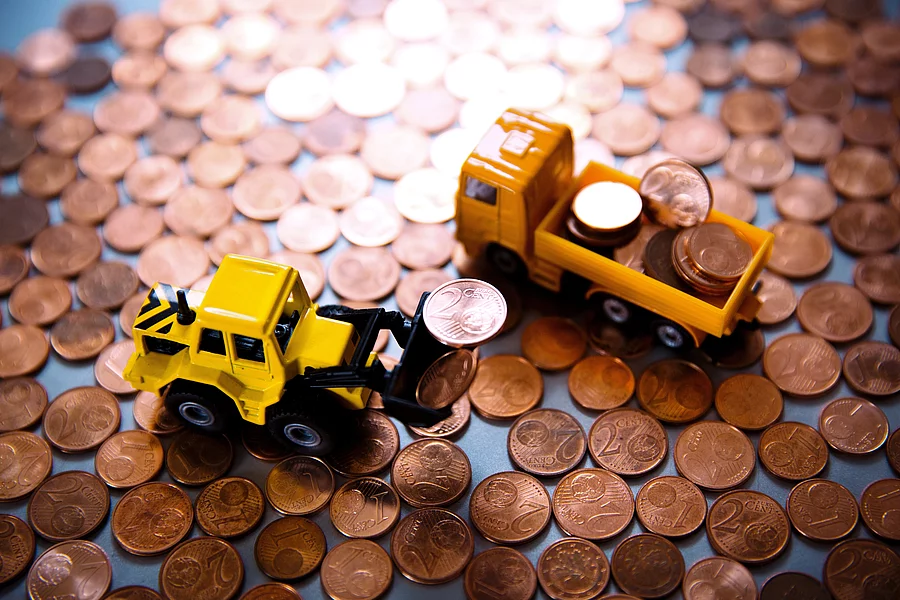 Toy cars among copper coins