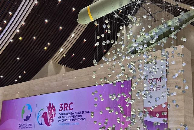 Installation of a bomb casing releasing bomblets above the Third Review Conference stage in Vientiane.